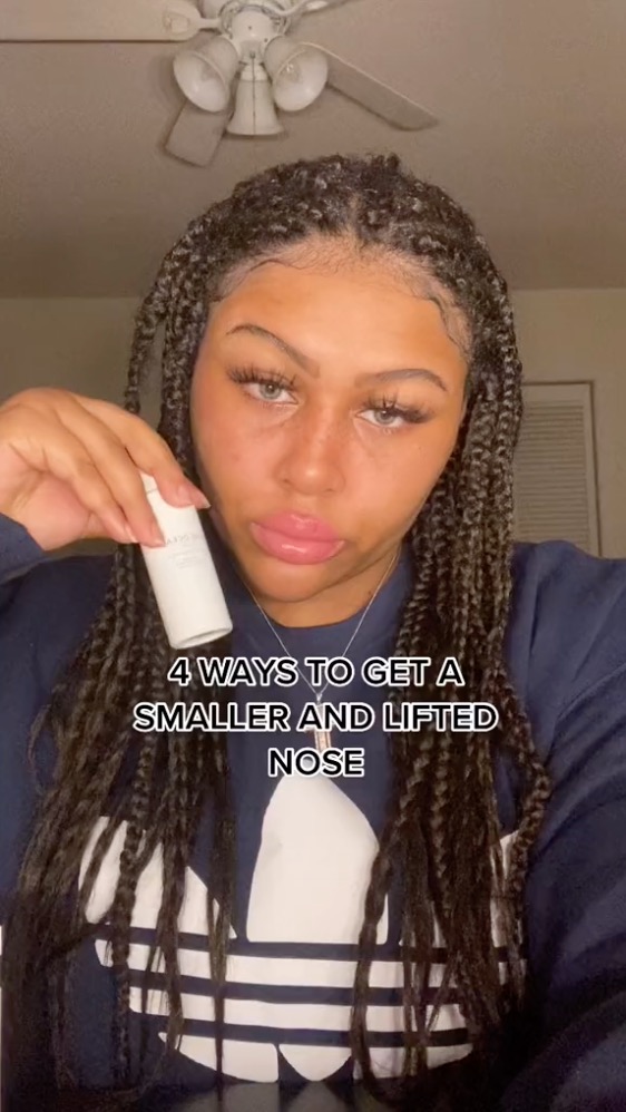 Jadyn poses with a bottle of moisturiser and pouts at the camera.