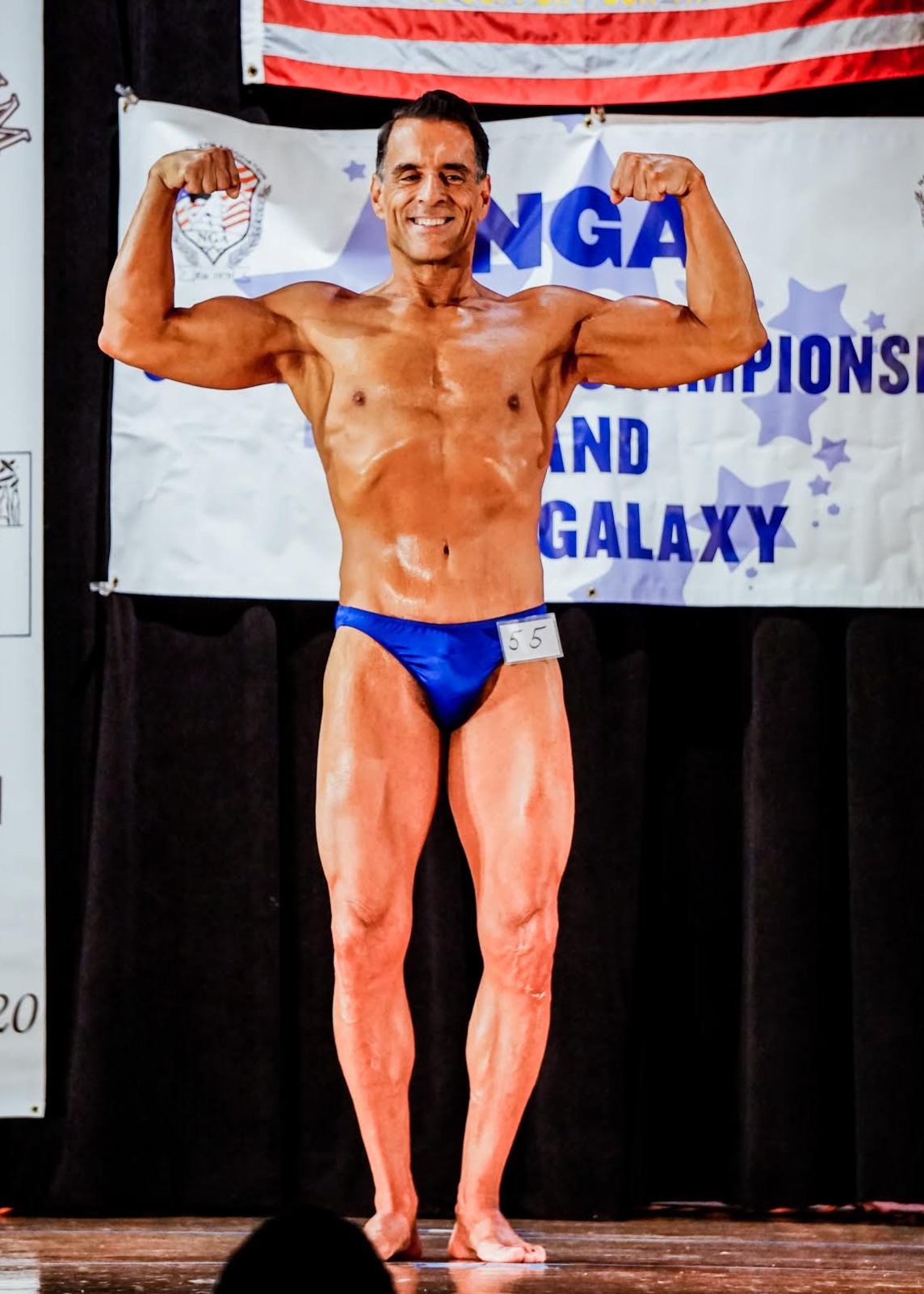 Greg poses as part of a bodybuilding competition.