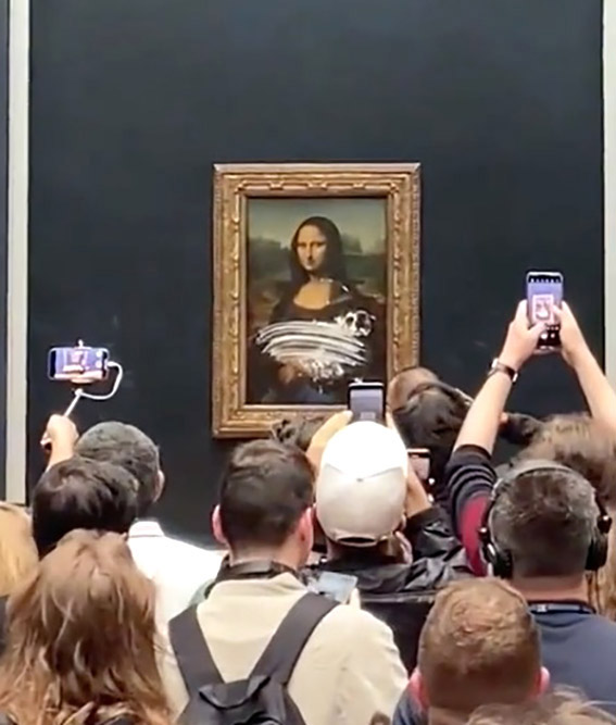 Up close shots of the Mona Lisa with a smear of cake and people filming
