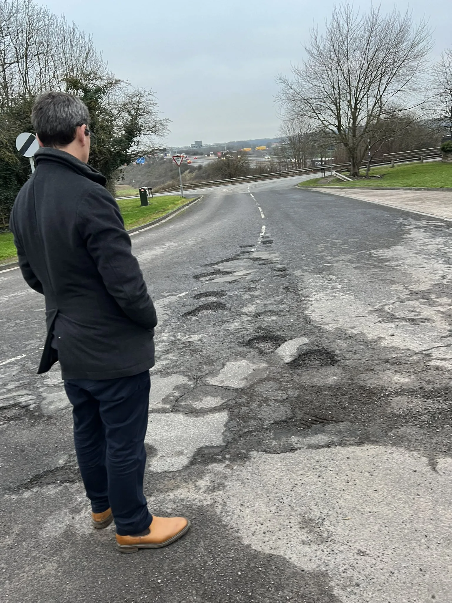 Nick Fletcher MP with the potholes on Bubup Hill.
