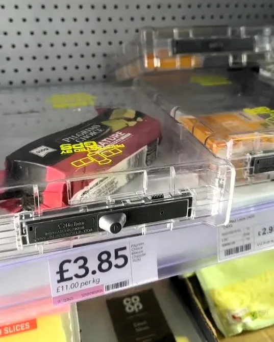 A video grab of Conor finding blocks of cheese inside security cases in his local Co-op goes viral on tiktok.
