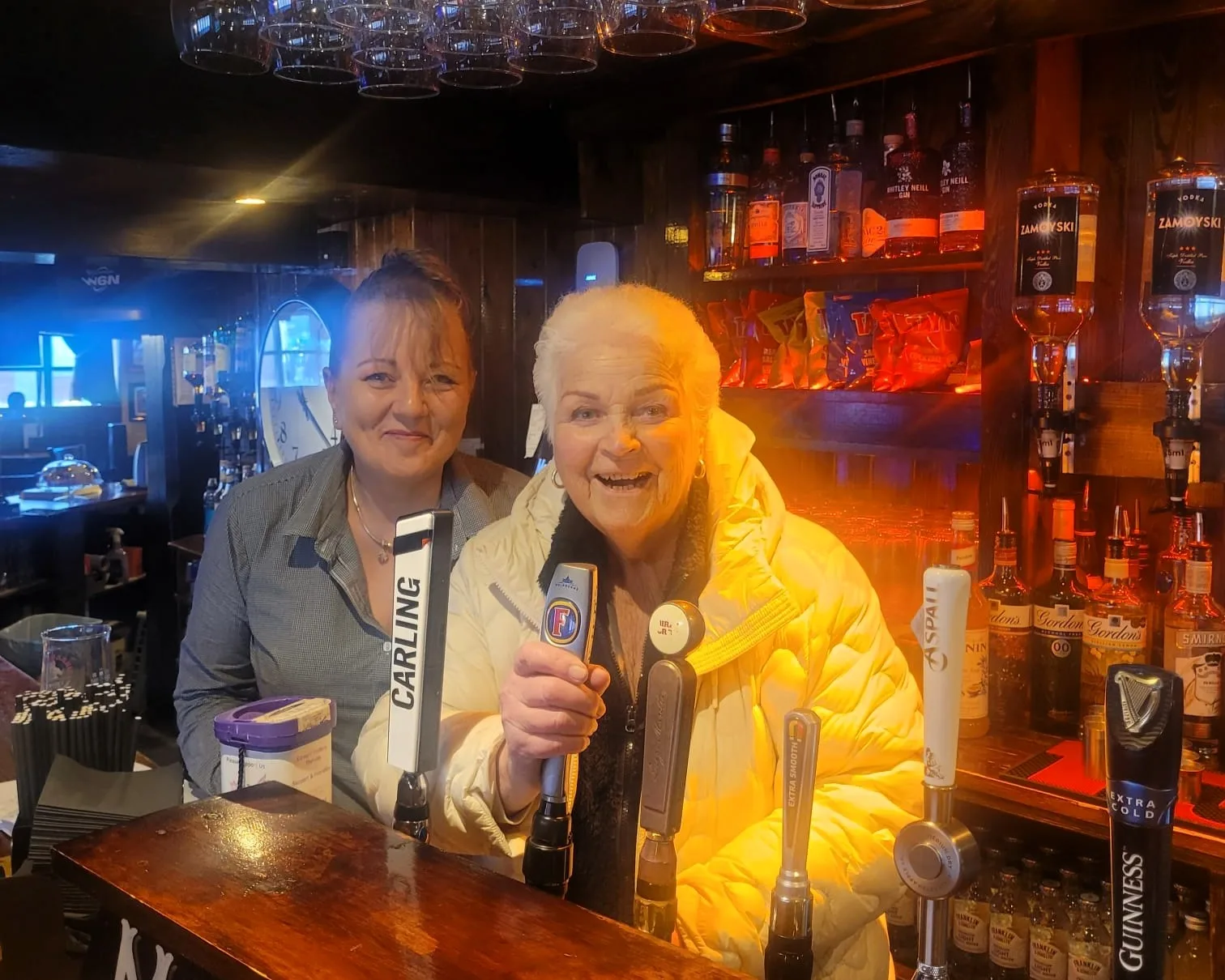 EastEnders icon Pam St Clement surprises pub-goers by pouring drinks at an Irish pub, channeling her famous character Pat Butcher. The 81-year-old actress charms patrons at McCafferty’s in Oxfordshire, reminiscent of her days at The Queen Vic. Fans applaud her timeless style and celebrate her brief return to the limelight.