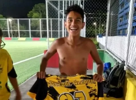 Tragic accident claims the life of 13-year-old Pablo Oliveira dos Santos as he's swept into a storm drain during heavy rain while washing his football boots. Devastated family mourns the loss of their football-loving son in Embu das Artes, Brazil.