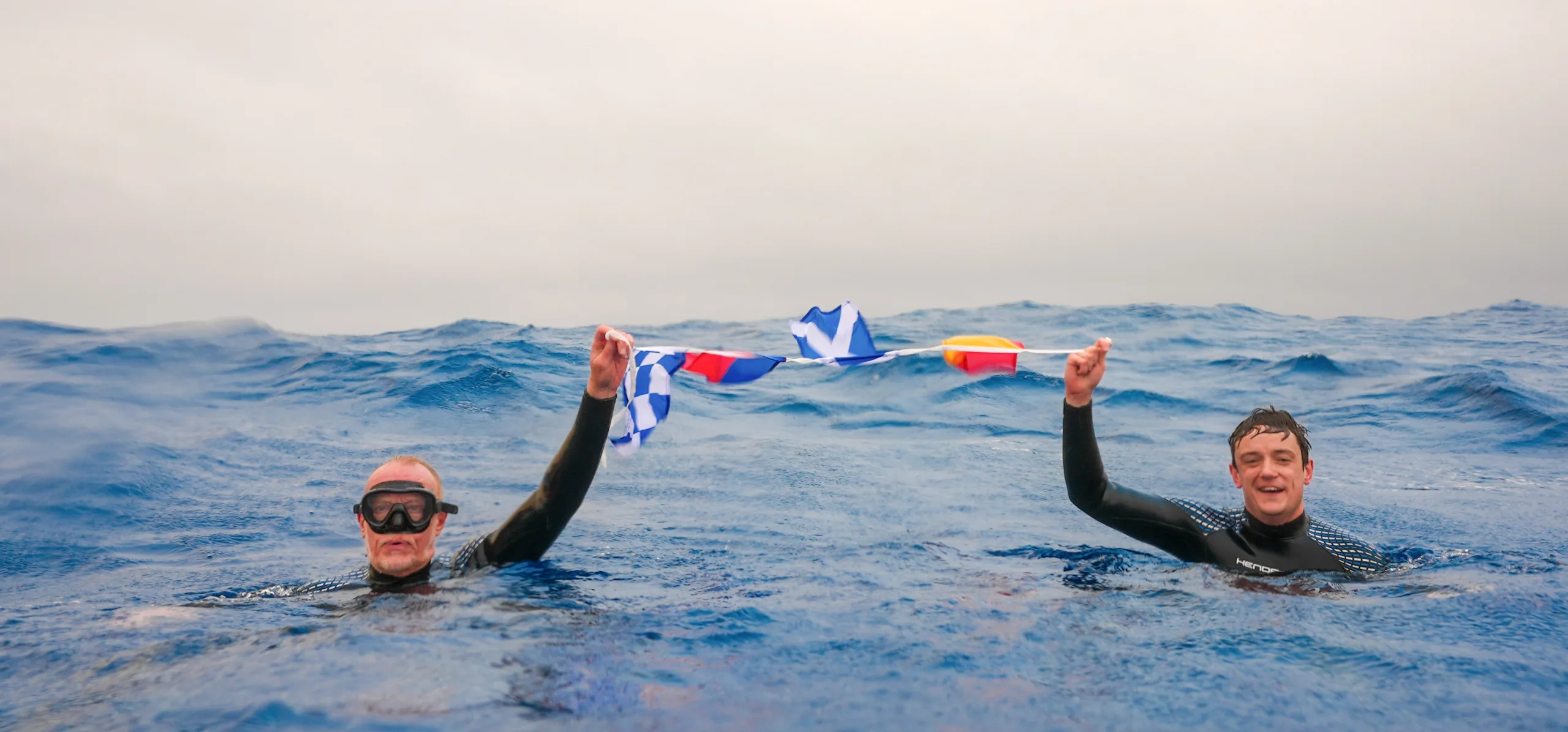 Explorer Chris Brown and his son Mika celebrate their successful expedition to Point Nemo, Earth's most remote spot, with a plunge into the Pacific.