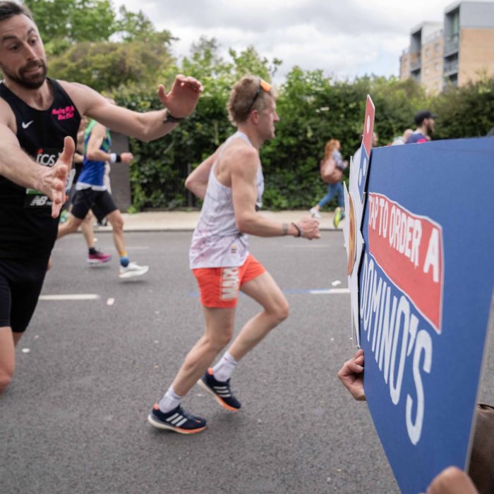 Runners ordering pizzas from order boards DURING the London Marathon