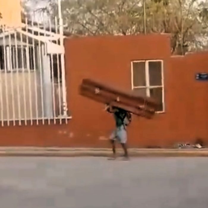 VIDEO: Bizarre moment man struts along street with ‘stolen’ coffin