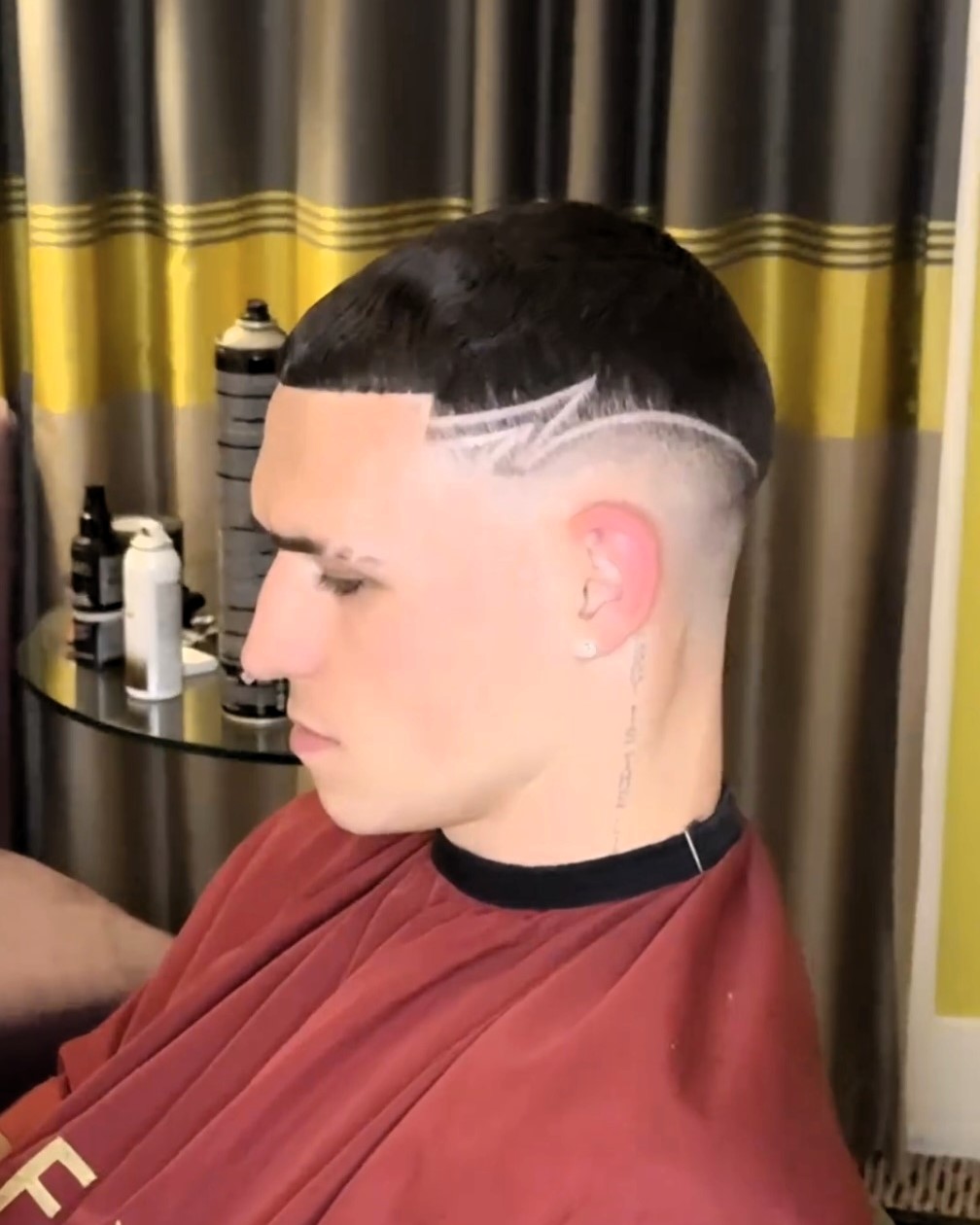 Phil Foden's new zig-zag tramline haircut draws mixed reactions, with fans mocking it as a kid's style while others praise the daring look.