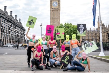 Protesters in bras and neon balaclavas gathered outside Parliament to inspire undecided women to vote, highlighting the importance of female participation in the upcoming election.