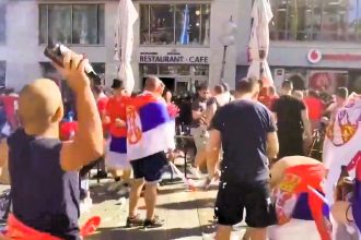 Serbian football fans clash with German riot police in Munich's Marienplatz, hurling beer bottles ahead of Euro 2024 match against Denmark. Serbia exits tournament after 0-0 draw.