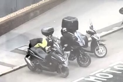 Brazen crooks steal moped in 13 seconds using an angle grinder on a busy London street. Despite pedestrians and traffic, they escaped with ease. Captured on video by onlookers.