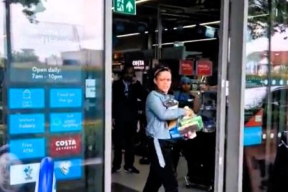 A woman walked out of a Co-op store with stolen goods, including Ferrero Rocher chocolates, and threatened an onlooker filming her. The incident occurred in Alperton, London.