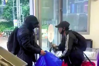 Two young crooks steal ice creams from a petrol station in northwest London. Caught on video, the duo casually filled a bag with lollies and fled. Locals react with disbelief.