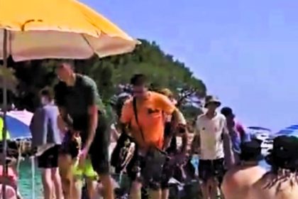 Stunned beachgoers in Mallorca watched as 20 migrants disembarked from a small boat onto a crowded shore, marking the fifth such arrival in the Balearic Islands that day.