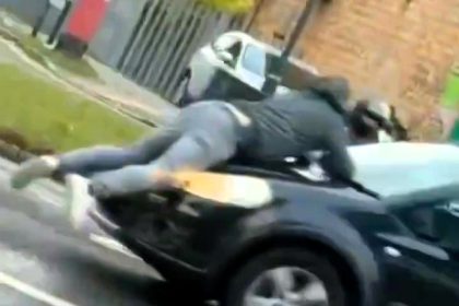 A road rage incident in London escalated as a man was filmed clinging to a car bonnet after being hit by the driver. The bizarre confrontation shocked onlookers.