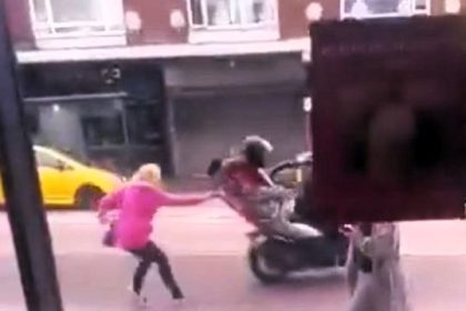Brave woman stops thieves from stealing her e-bike by yanking one off a moped, shocking bystanders in Borehamwood. Heroic act caught on camera outside a Starbucks.
