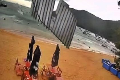 Beach bar staff narrowly avoid injury as a flying roof crashes down during a windstorm in Ilha Grande, Brazil. Quick reflexes save them as high winds cause chaos.
