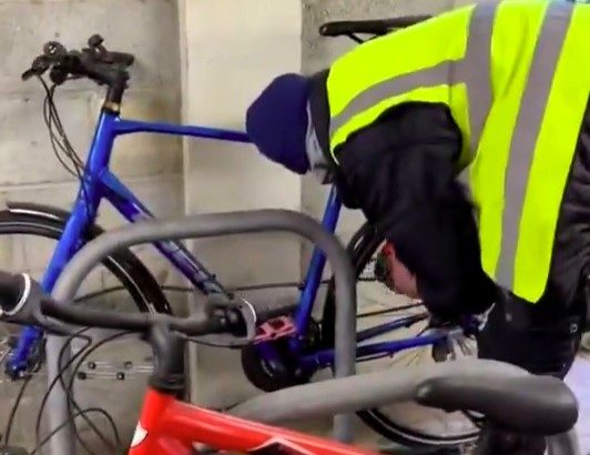 A brazen thief steals a bike in East London, boldly riding off despite being chased on foot. The theft was caught on camera, sparking outrage among locals.