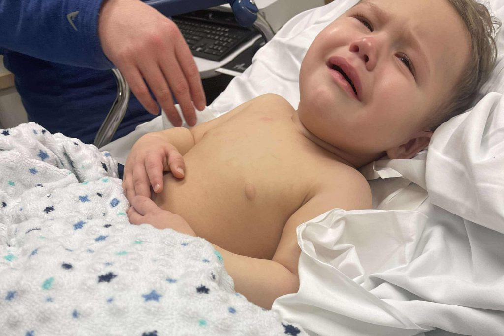 Toddler survives life-threatening injury after swallowing button battery, leaving parents urging others to avoid battery-powered toys to prevent similar accidents.