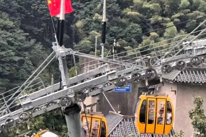 A tourist fell 30ft from a cable car in China after strong winds caused the doors to open. She survived with non-life-threatening injuries. An investigation is ongoing.