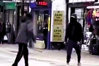 Two men wielding machetes clashed in a shocking medieval-style fight on East Ham High Street, London, as stunned shoppers, including children, looked on.