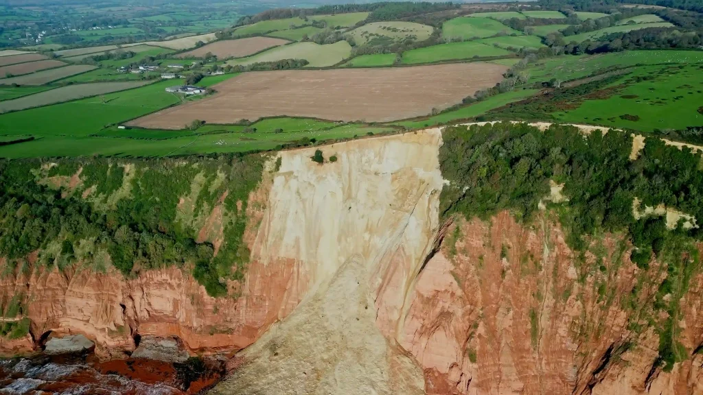 Warning issued after massive cliff collapse in Sidmouth, Devon, closing coastal path. Beach-goers advised to stay clear due to risk of further rock falls.