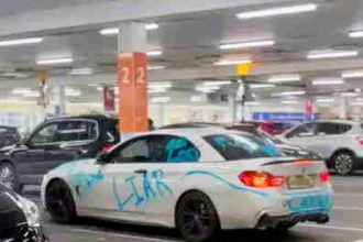 BMW driver’s car vandalized with “Cheater” and “Liar” graffiti at Tesco Extra in Slough, leaving locals amused and sparking jokes about the driver’s love life.