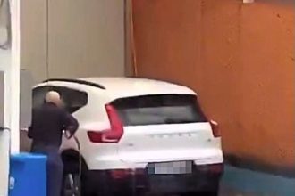 A car owner in storm-hit Malaga cleans his SUV amid torrential rain and winds from Dana, sparking bewilderment as severe weather wreaks havoc across Costa del Sol.