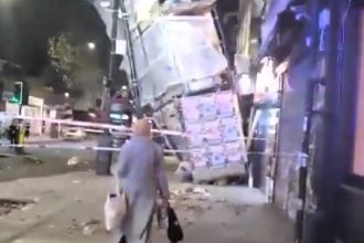 A woman narrowly avoided danger after walking under collapsed scaffolding from Storm Bert, ignoring emergency tape, before being stopped by a quick-thinking firefighter.