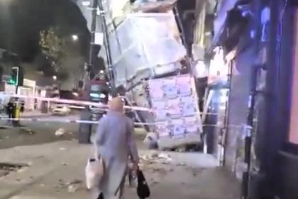 A woman narrowly avoided danger after walking under collapsed scaffolding from Storm Bert, ignoring emergency tape, before being stopped by a quick-thinking firefighter.