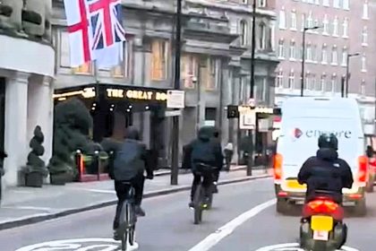 E-bike gang steals pedestrian's phone outside £2,250-a-night Mayfair hotel. Dash cam captures brazen theft in London. Locals react with outrage over rising crime.