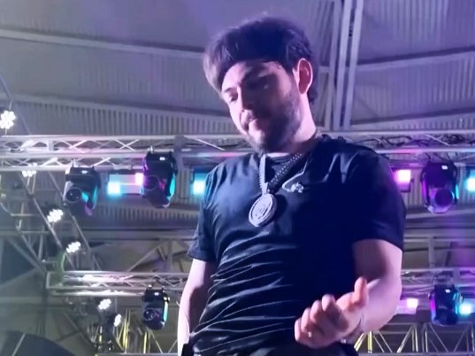 Mexican rapper Tito Double P hit by beer can during concert, forced off stage. Incident caught on camera, clips go viral on TikTok, sparking mixed reactions online.