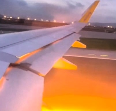 Terrifying moment as flames burst from Vueling plane engine during takeoff in Barcelona. Passengers safely evacuated; investigation into engine blaze underway.