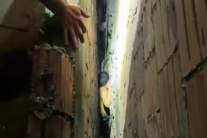 Firefighters in Manaus rescue man stuck in a narrow gap between walls after a rooftop fall. Dramatic footage shows the careful wall demolition needed to free him safely.