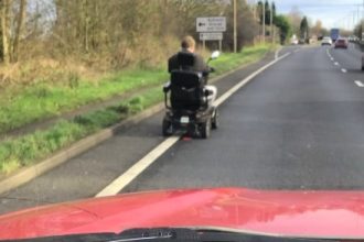 Mobility scooter rider causes chaos on A14, dodging police and oncoming traffic at 8mph. Witnesses stunned as tailbacks and safety concerns escalate.