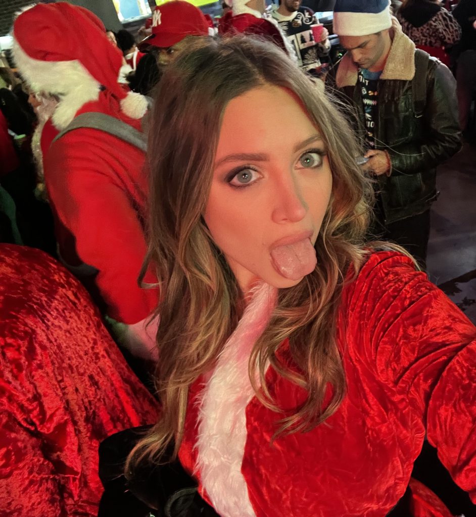 A controversial model, Ava Louise, reportedly sparked outrage at New York City's SantaCon by performing a public act with a man dressed as Father Christmas.