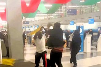 Chaos erupts at Chicago O’Hare Airport as passengers and staff clash in a wild brawl using wet floor signs and stanchion poles. No arrests made; investigation ongoing.