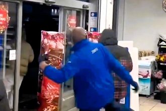 A Tesco worker is praised for humorously kicking a fleeing shoplifter with stolen wine in Kilburn. Locals cheer the bold move while questioning the role of security.