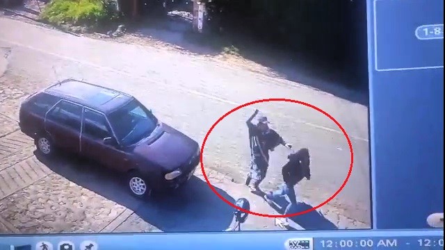 A Colombian father-of-two is on the run after allegedly attacking his ex-partner with a machete in front of their children. She miraculously survived multiple life-threatening injuries.