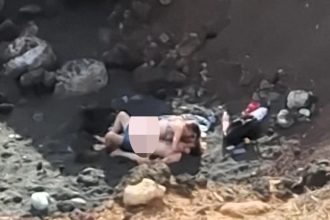 A family was stunned after spotting a couple "romping" on a Tenerife beach near children playing, with the brazen act caught on camera during a casual lunch outing.