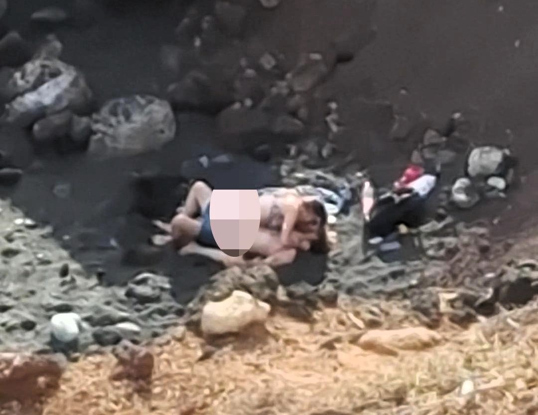 A family was stunned after spotting a couple "romping" on a Tenerife beach near children playing, with the brazen act caught on camera during a casual lunch outing.