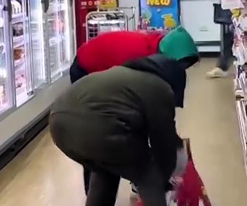 Two hooded thieves raided a Sainsbury’s in East London, stuffing a bag with chocolates like Dairy Milk and Kinder Buenos. Shocked shoppers filmed the bizarre theft as staff stood powerless.