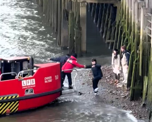 Three tourists had to be rescued from the River Thames after getting stranded by the rising tide near Tower Bridge. The incident sparked backlash over wasted emergency resources.