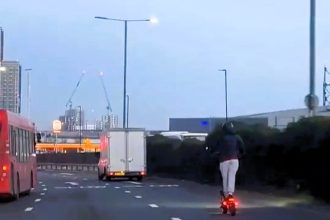 A reckless e-scooter rider was caught speeding at 40mph in the outside lane of a busy London road, overtaking cars and shocking onlookers with the dangerous stunt.