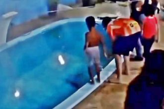 A boy pushed his older brother into a pool with a crocodile resting at the bottom, sparking laughter before panic. The risky prank was filmed at a home in Honduras.