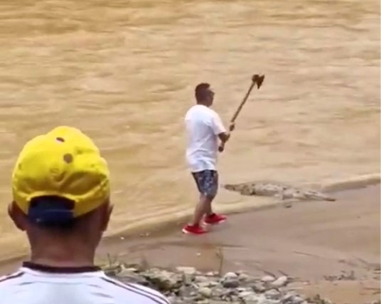 A man who tried to attack a crocodile with an axe in Ecuador was nearly mauled as the reptile fought back. He now faces possible criminal charges after the viral incident.