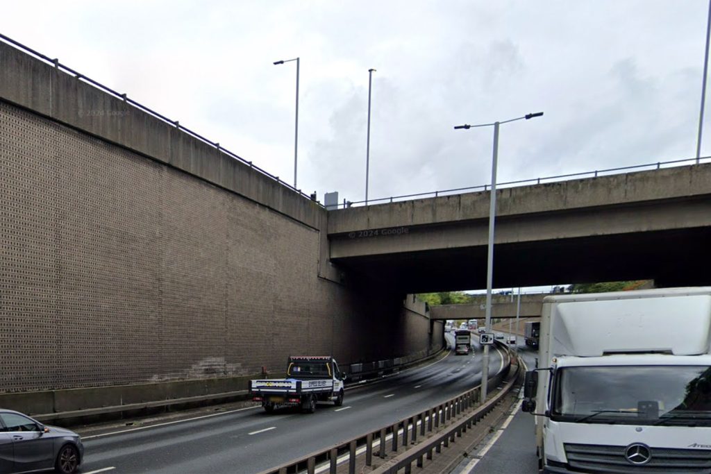 A suspect dubbed 'Spider-Man' fled police on foot along the A406 in London, scaling a 50ft wall before falling and being arrested, causing major traffic delays.