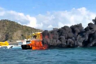 A tourist boat carrying 92 people caught fire off Santa Marta, Colombia, forcing passengers to jump into the sea. All were rescued safely, and an investigation is underway.