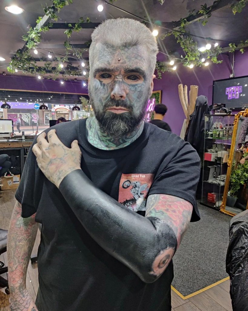 Britain’s most tattooed man faces daily judgment as people refuse to sit next to him on transport and secretly snap photos, but he refuses to let it hold him back.