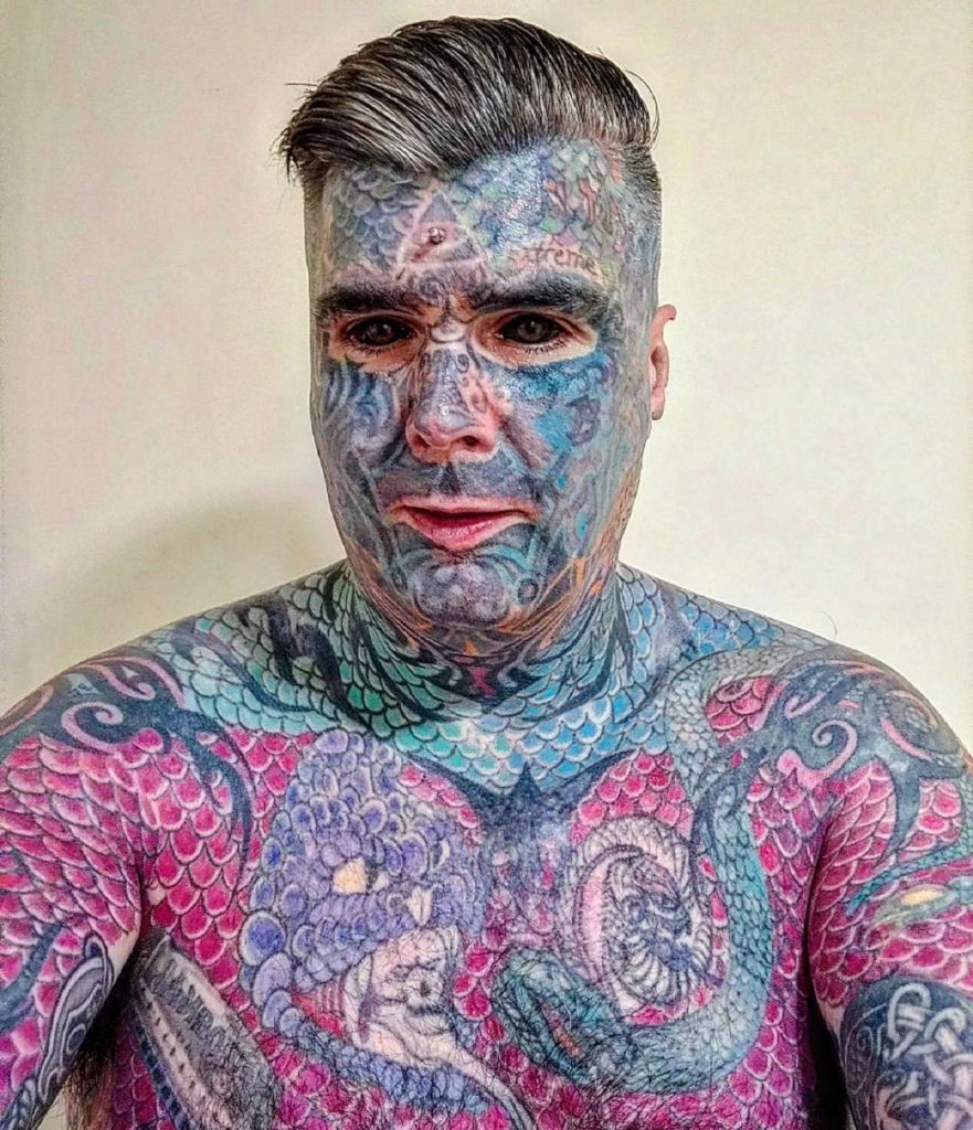 Britain’s most tattooed man faces daily judgment as people refuse to sit next to him on transport and secretly snap photos, but he refuses to let it hold him back.
