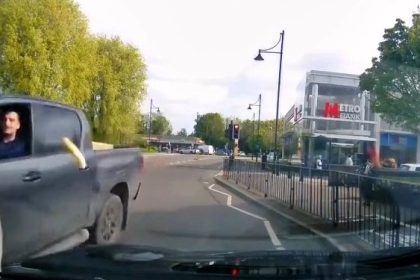 A driver hurled a McMuffin at a parked car in a bizarre road rage incident near a McDonald’s in Surrey before speeding off as the odd moment was caught on dash cam.